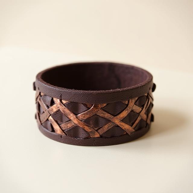 Woven copper and leather arm adornment